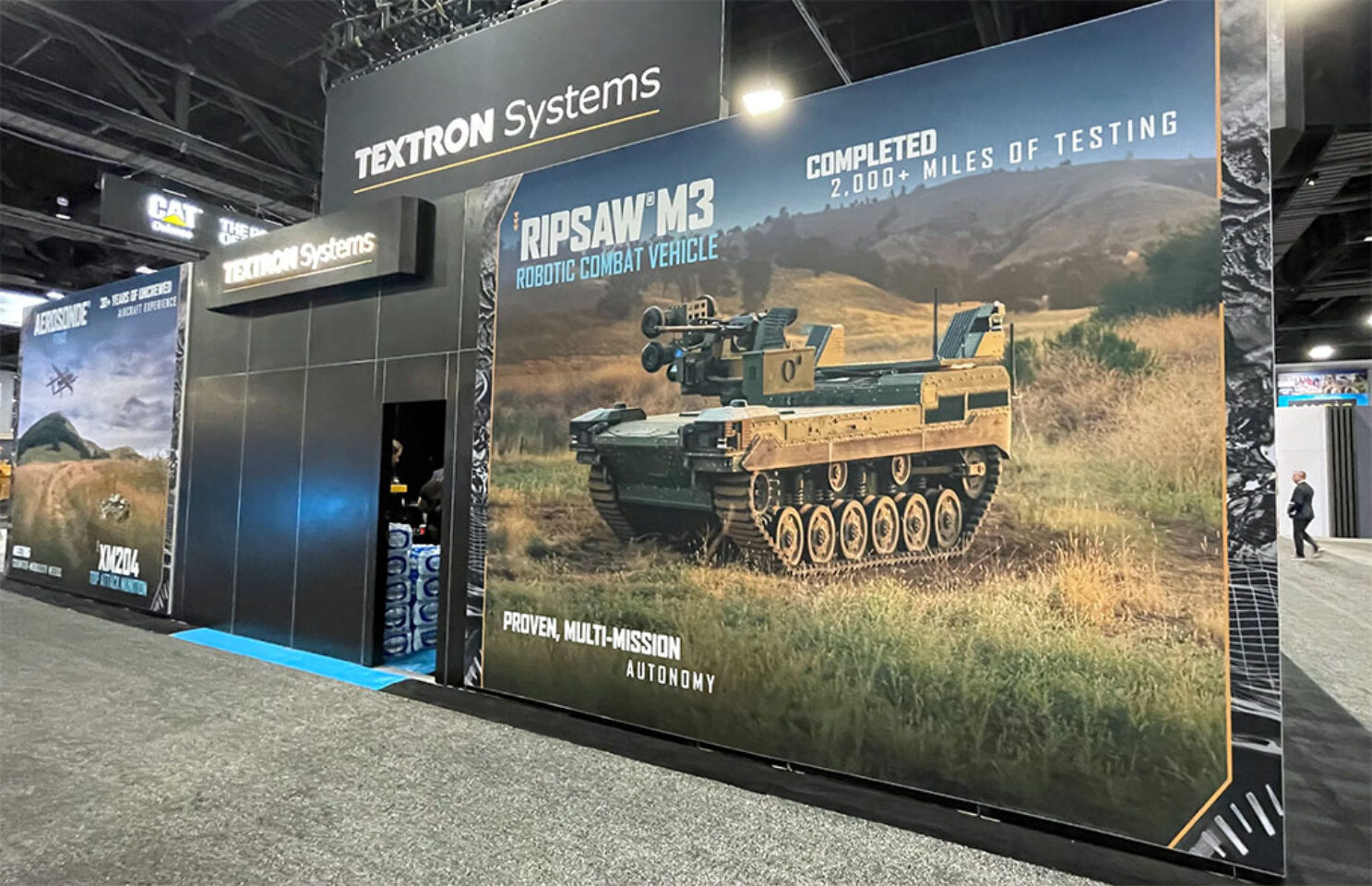 Large back wall trade show graphic featuring land vehicles.